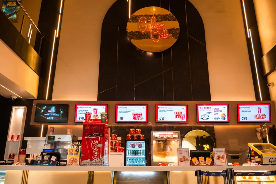The Galaxy Cafe neon sign above the menu screens and counter